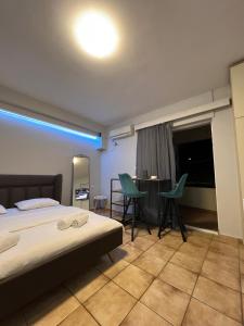a bedroom with a bed and a table and chairs at Larisa City Ap 5 with parking in Larisa