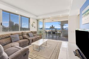 a living room with a couch and a table at Sands On Greenmount Unit 4 in Gold Coast