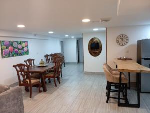 a dining room with a table and chairs at ApartaHotel Encanto Inn in Filandia