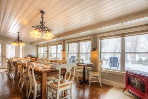 a dining room with a large wooden table and chairs at Antlers on the Creek Bed & Breakfast in Durango
