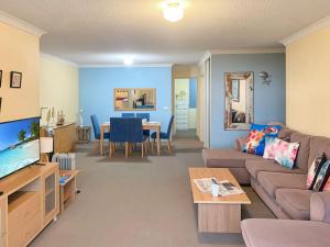 a living room with a couch and a table at Portside Unit 12 1 Donald Street in Nelson Bay