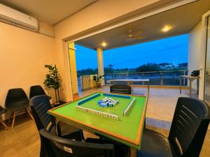 a room with a ping pong table and chairs at Canoe and Fishing , Free Pickup in Batam Center