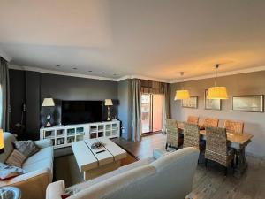 a living room with a couch and a table at Rooftop Pool with Views in Motril