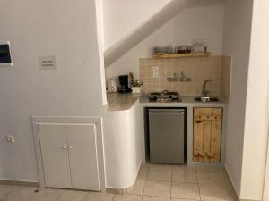 a small kitchen with a sink and a counter at Pension Irene 2 in Naxos Chora