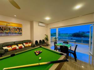Billiards And Karaoke, Free Pickup في Sengkuang: غرفة معيشة مع طاولة بلياردو وأريكة