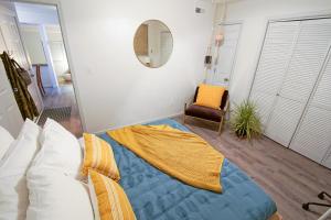 a bedroom with a bed with a blanket on the floor at [1] Chic & Cozy Retreat Walk to KU/Mass/Dining! in Lawrence