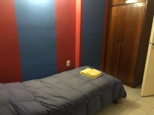 En eller flere senge i et værelse på Departamento en Río Ceballos