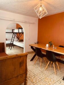 a dining room with a table and a bunk bed at Lool Beh Hostal in San Miguel de Allende