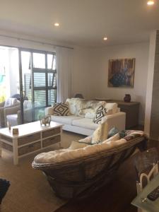 a living room with a couch and a table at Tairua Marina Villa in Tairua
