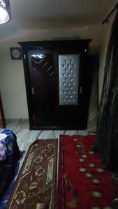 a room with a black door and a red rug at night holiday in in Alexandria