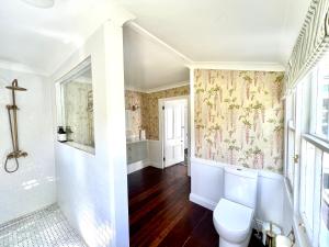 a bathroom with a toilet and a sink at The Cottage Farm Stay - Grandchester in Grandchester