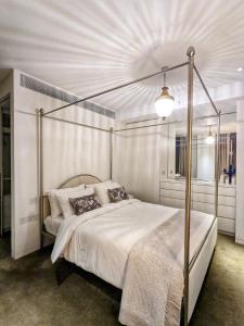 a bedroom with a bed with a metal canopy at Soho West End in London