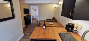 a kitchen with a table with a bottle of wine on it at À mi-chemin in Marcillac-Vallon