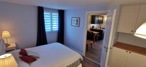 a bedroom with a bed and a window and a desk at À mi-chemin in Marcillac-Vallon