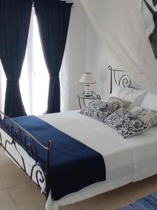 a bedroom with a bed with a blue and white comforter at Seaside holiday house Cove Tri luke, Korcula - 22092 in Vela Luka