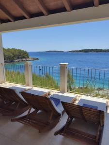 a balcony with chairs and a view of the ocean at Seaside holiday house Cove Tri luke, Korcula - 22092 in Vela Luka