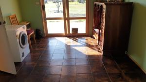 a hallway with a door and a tile floor at Stay with the nature and stars in Little River