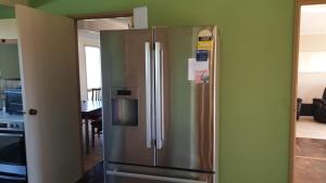 a kitchen with a stainless steel refrigerator in a room at Stay with the nature and stars in Little River