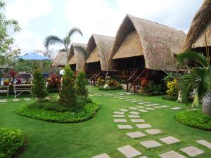 a resort with a garden with a path in the grass at Harta Lembongan Villas in Nusa Lembongan