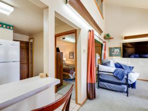 a kitchen and living room with a refrigerator and a couch at Warm McCall Condo Half-Mile to Payette Lake! in McCall