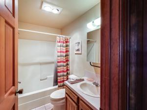 a bathroom with a sink and a toilet and a shower at Warm McCall Condo Half-Mile to Payette Lake! in McCall +21 photos