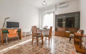a dining room with a table and chairs and a television at Stunning Apartment In Chiaramonte Gulfi With Wi-fi in Chiaramonte Gulfi