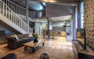 a large living room with a couch and a table at 2 Bedroom Awesome Home In Les Mées in Les Mées