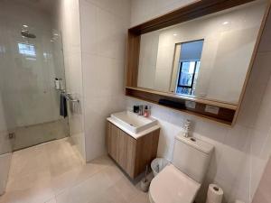 a bathroom with a toilet and a sink and a shower at Four-Bedroom Town House in Port Melbourne in Melbourne +28 photos