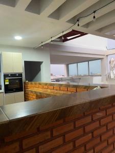 a kitchen with a brick counter top in a room at Hotel Don Felipe in Ríohacha