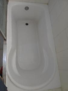 El baño incluye bañera blanca con lavamanos. en Típica casa dominicana a 12 minutos de la playa, en Las Galeras