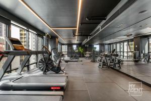 een fitnessruimte met loopbanden en machines in een gebouw bij 2 Bedroom Apartment in Southbanks Stature Building in Melbourne