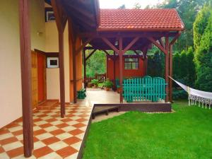 a gazebo with a checkered floor in a yard at Holiday Home Kubus in Poddąbie