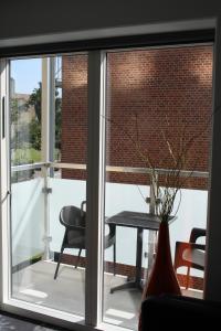 a window view of a patio with a table and chairs at ApartHotel Faber in Aarhus