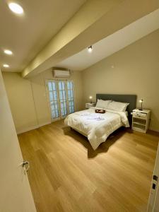 a bedroom with a large bed and a wooden floor at Casa Del Cable Carril in Chilecito +13 photos