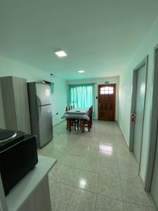 a kitchen and dining room with a table and a refrigerator at Jardines del Calafate in El Calafate