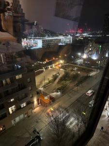 a view of a city at night with lights at Entire flat in Ealing in London