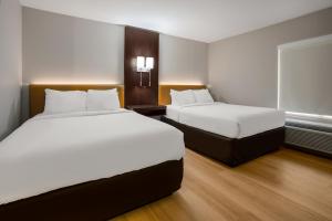 Un pat sau paturi într-o cameră la The Marco Hotel Lake Charles