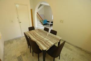 a dining room with a table and chairs at ROHAN HOUSE in Nashik