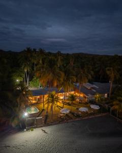 an aerial view of a resort with palm trees at night at Bella Vista Hotel Boutique in San Miguel