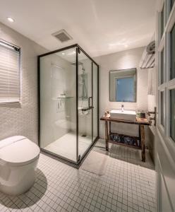 uma casa de banho com um chuveiro, um WC e um lavatório. em Shenzhen Shekou No.6 Garden Hotel (Sea World) em Shenzhen