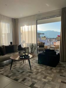 a living room with a couch and a table at Warm apartment + private free park. in Vétraz-Monthoux