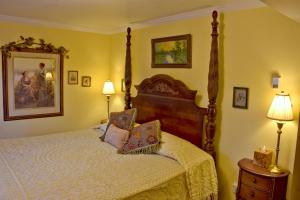 a bedroom with a large bed and two lamps at Big Yellow Inn in Cedar City