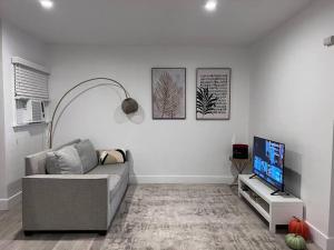 a living room with a couch and a flat screen tv at Cozy 1BR 1BA apt center of LA steps from the Grove in Los Angeles