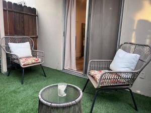 two chairs and a glass table on a porch at Cozy 1BR 1BA apt center of LA steps from the Grove in Los Angeles