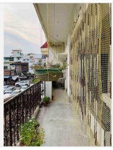 a balcony with two baskets on the side of a building at Private suite with living room in Kānpur