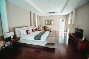 um quarto grande com uma cama grande e uma televisão em Javana Royal Villas em Seminyak