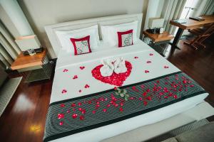 a bed with a heart made out of red hearts at Javana Royal Villas in Seminyak