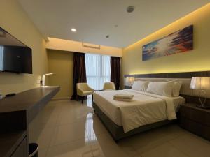 a hotel room with a bed and a desk at QUINCE HOME GRAND ION DELEMEN GENTING HIGHLANDs in Genting Highlands