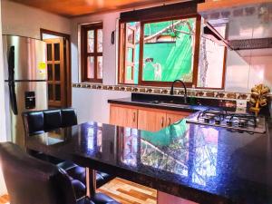 a kitchen with a counter top and a refrigerator at Casa Custodia in Ráquira