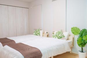 Postel nebo postele na pokoji v ubytování Beachside base KURUWA